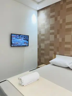 a bedroom with a bed with a television on the wall at Sweet home in Marrakech