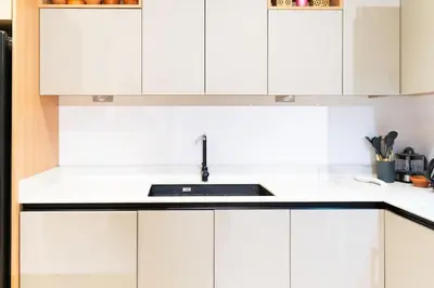 a white kitchen with white cabinets and a sink at Elegant Villa Free Breakfast Heated Pool Spa in Marrakech
