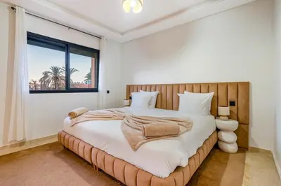 a bedroom with a large bed and a window at Grand duplex 4 ch - Piscine - Marrakech in Marrakech