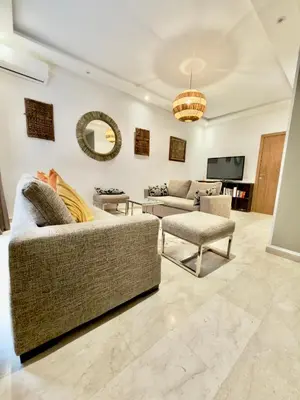 a living room with two couches and a tv at Charmant Duplex 2BR - quartier Hivernage - Piscine in Marrakech