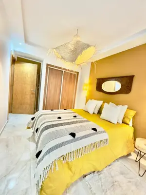 a bedroom with a large bed in a room at Charmant Duplex 2BR - quartier Hivernage - Piscine in Marrakech
