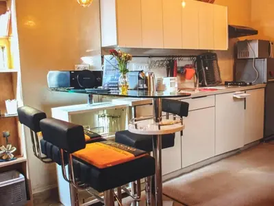 a kitchen with a counter and some chairs in it at Urban Escape in Marrakesh in Marrakech