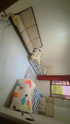 a room with three pillows and a lamp on the wall at Chic & Cozy Apartment in Marrakech