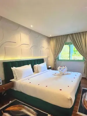 a bedroom with a large bed with two stuffed animals on it at Stylish Retreat in Marrakech