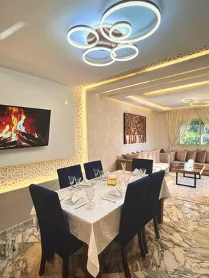 a dining room with a table with wine glasses on it at Stylish Retreat in Marrakech
