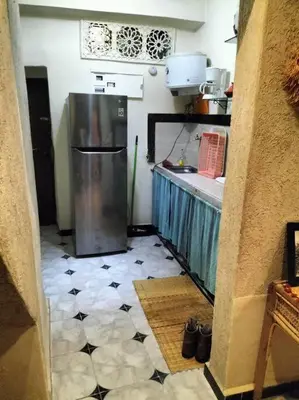 a kitchen with a refrigerator in the middle of a room at Dar tranquille in Marrakech