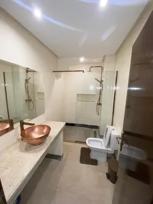 a bathroom with a wooden bowl sink and a toilet at Spacious studio with pool Guéliz in Marrakech