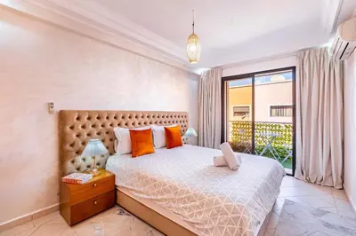 a bedroom with a large bed and a window at Appartement spacieux 83 m carré Wi Fi Marrakech in Marrakech