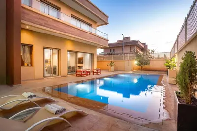 a swimming pool in the backyard of a house at Villa de luxe et plaisir in Marrakech