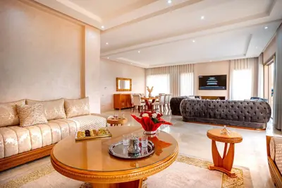 a living room with a couch and a table at Villa de luxe et plaisir in Marrakech