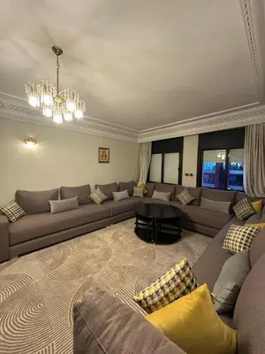 a living room with a couch and a table at Tay Home in Marrakech