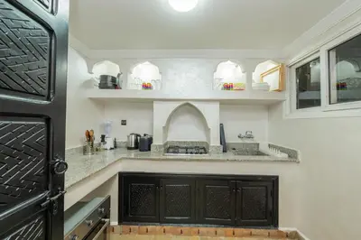 a kitchen with a stove and a counter top at Riad Marrakech 4-bedroom Riad in the heart of Marrakesh with Pool in Marrakech