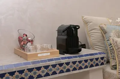 a coffee maker on a table next to a couch at Riad Marrakech 4-bedroom Riad in the heart of Marrakesh with Pool in Marrakech