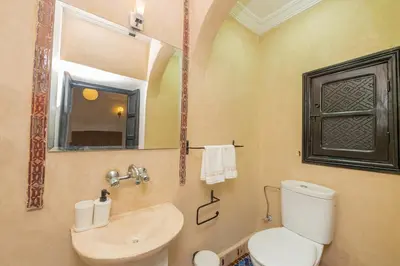 a bathroom with a toilet and a sink and a mirror at Riad Marrakech 4-bedroom Riad in the heart of Marrakesh with Pool in Marrakech
