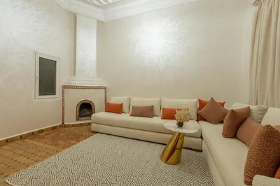 a living room with a couch and a fireplace at Riad Marrakech 4-bedroom Riad in the heart of Marrakesh with Pool in Marrakech