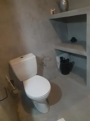 a bathroom with a white toilet in a room at Riad ICA in Marrakech