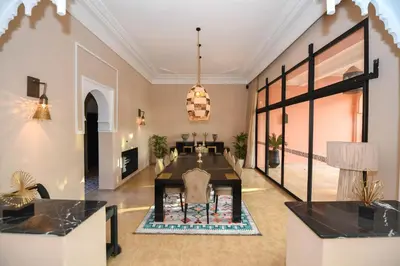 a living room with a table and a dining room at Royal Moroccan House in Marrakech