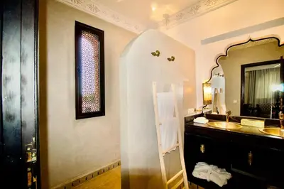 a bathroom with a sink and a mirror at Royal Moroccan House in Marrakech