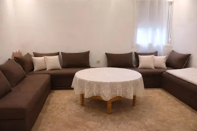 a living room with a couch and a table at appartement pour famille ou femme in Marrakech