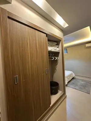 a closet with a wooden door in a room at Guéliz 5 min away - Quiet - Pool & Parking in Marrakech