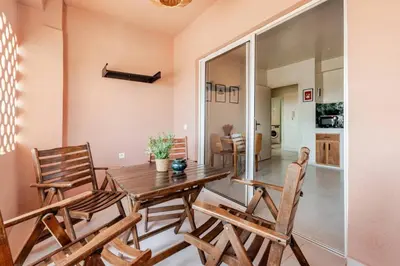 a dining room with a wooden table and chairs at 3 chambres lumineux au centre de Marrakech in Marrakech