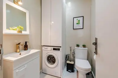 a bathroom with a toilet sink and a washing machine at 3 chambres lumineux au centre de Marrakech in Marrakech
