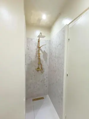 a bathroom with a shower with a towel rack at 3 chambres lumineux au centre de Marrakech in Marrakech