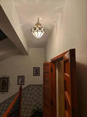 a room with a hallway with a chandelier and a staircase at Riad Palm Oasis Marrakech in Marrakech