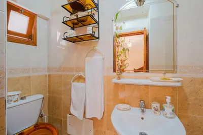 a bathroom with a toilet and a sink and a mirror at Riad Palm Oasis Marrakech in Marrakech