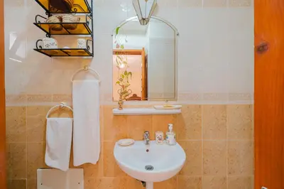 a bathroom with a sink and a mirror at Riad Palm Oasis Marrakech in Marrakech