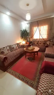 a living room with a couch and a table at Pied-à-terre Calme & Climatisé à 5 min du Centre in Marrakech