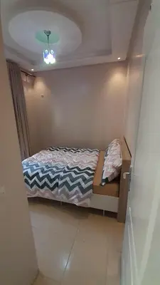 a small bedroom with a bed and a ceiling at Pied-à-terre Calme & Climatisé à 5 min du Centre in Marrakech