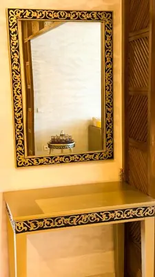 a mirror on a wall with a bench under it at Marrakech Cozy Family Home piscine et wifi in Marrakech