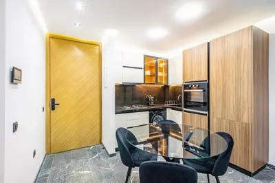 a kitchen with a glass table and black chairs at Modern apartment, design and cozy relaxing stay in Marrakech