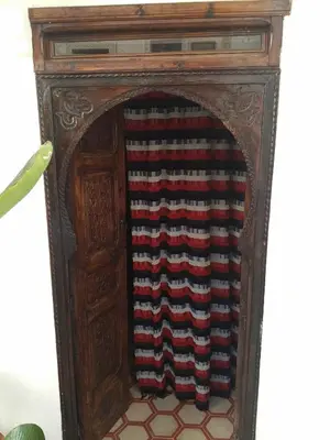 an old wooden fireplace with a red white and blue at Riad Green Atlas in Marrakech