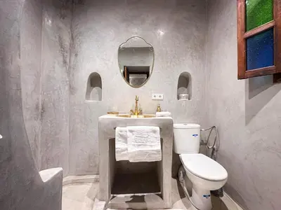 a bathroom with a toilet and a sink and a mirror at Riad Green Atlas in Marrakech