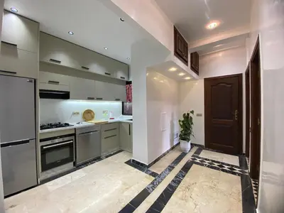a kitchen with stainless steel appliances and a black door at appartment L'Hivernage in Marrakech