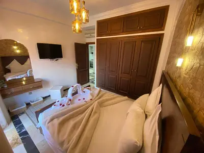 a bedroom with a bed and a tv in a room at appartment L'Hivernage in Marrakech