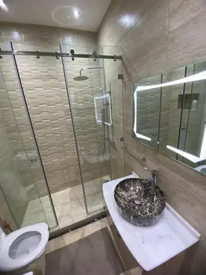 a bathroom with a sink and a shower and a toilet at appartment L'Hivernage in Marrakech
