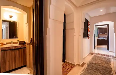 a bathroom with a sink and a mirror at Appartement idéal a l'hivernage in Marrakech