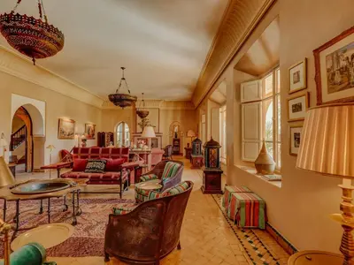 a living room with a red couch and chairs at Casa Memoria in Marrakech