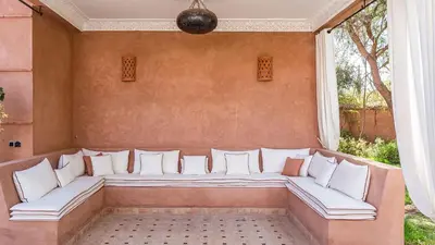 a large couch in a room with a window at Villa Rehame in Oulad Jellal