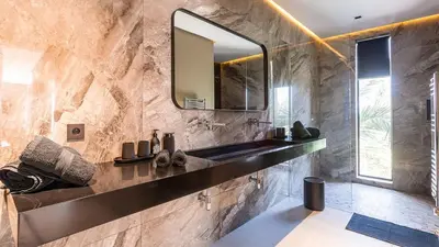 a bathroom with a sink and a mirror at Villa Olfa in Oulad Ikhia