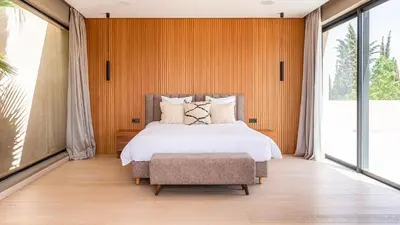 a bedroom with a bed and a large window at Villa Olfa in Oulad Ikhia