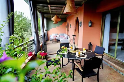 a patio with a table and chairs on a balcony at Nassim Al Noor in Marrakech