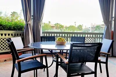 a table with chairs and a bowl of bananas on it at Nassim Al Noor in Marrakech
