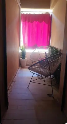 a window with a pink curtain in a room at Le lux de gueliz in Marrakech