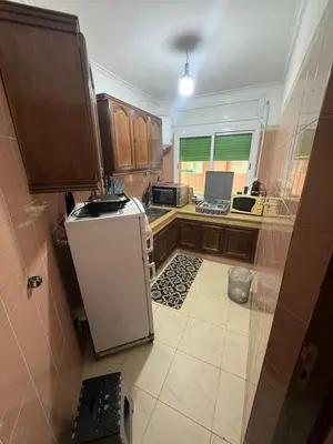 a kitchen with a small white refrigerator in it at appartement Yasmine à Marrakech in Marrakech