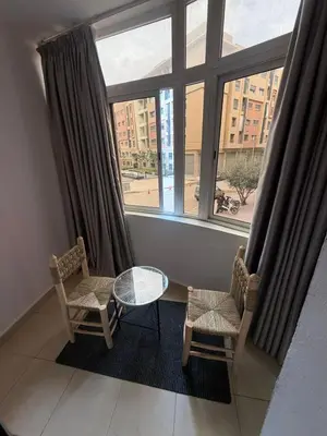 a room with a table and two chairs and a window at appartement Yasmine à Marrakech in Marrakech