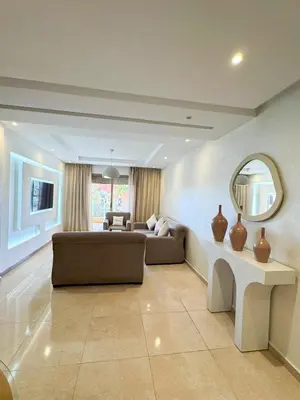 a living room with a couch and a mirror at Noraya Home - Secure residence with pool in Marrakech